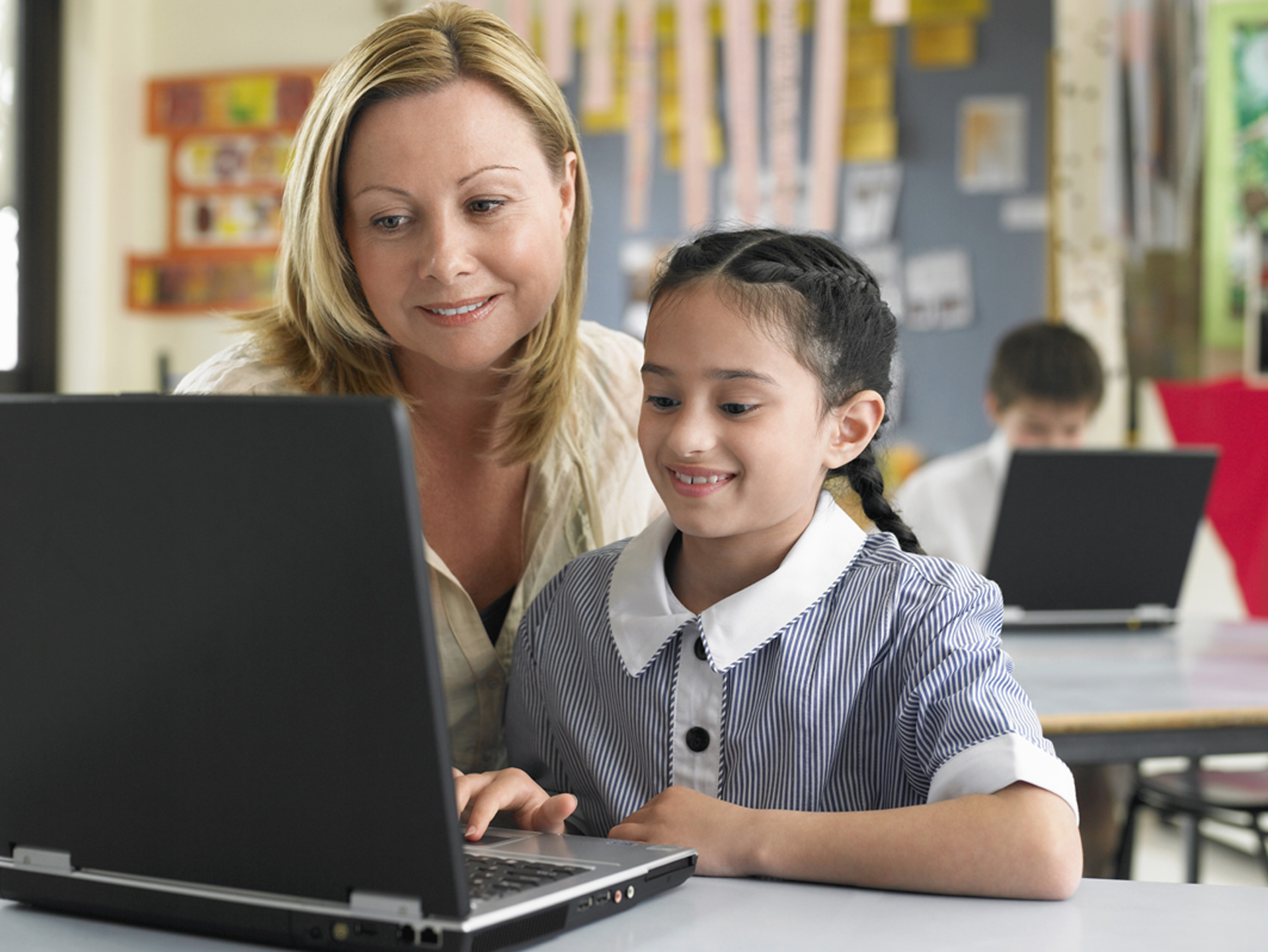 Young-School-Girl-on-Laptop-with-Teacher1440
