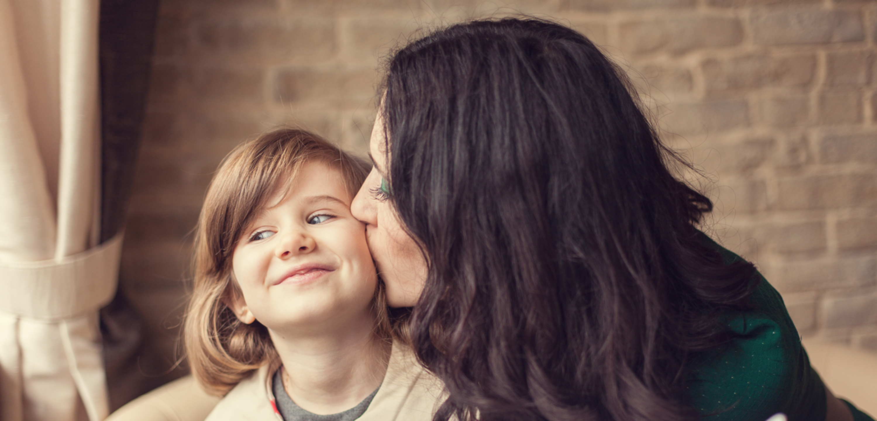 Mother-Kissing-Dauther-on-Cheek1440