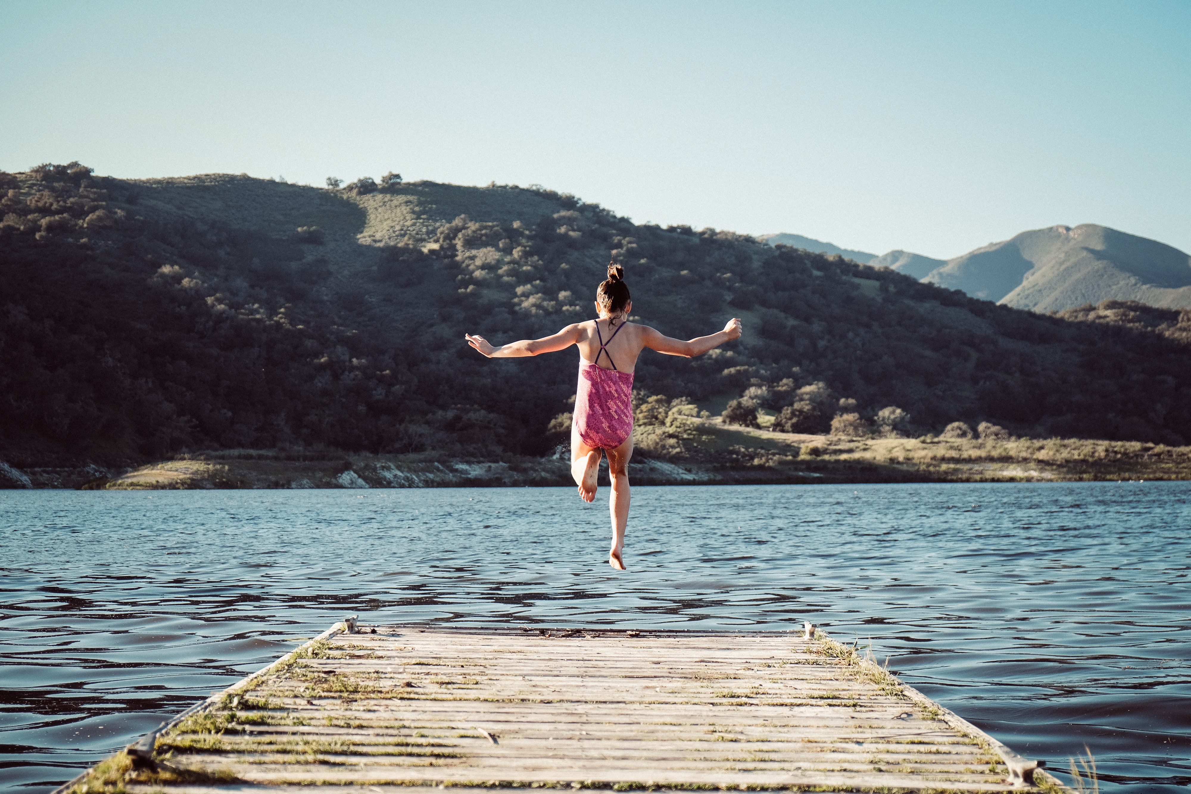 Girl jumps from pier into water