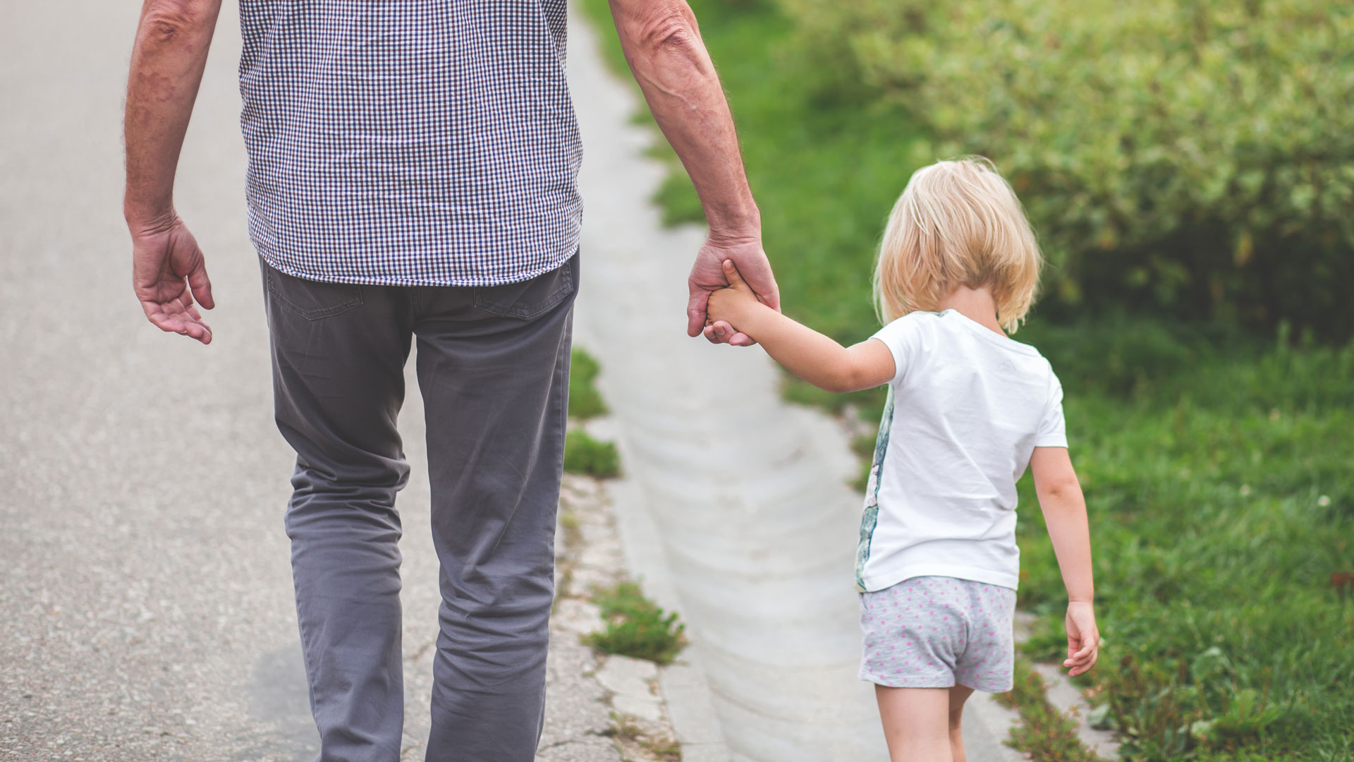 Man holding young girls hand