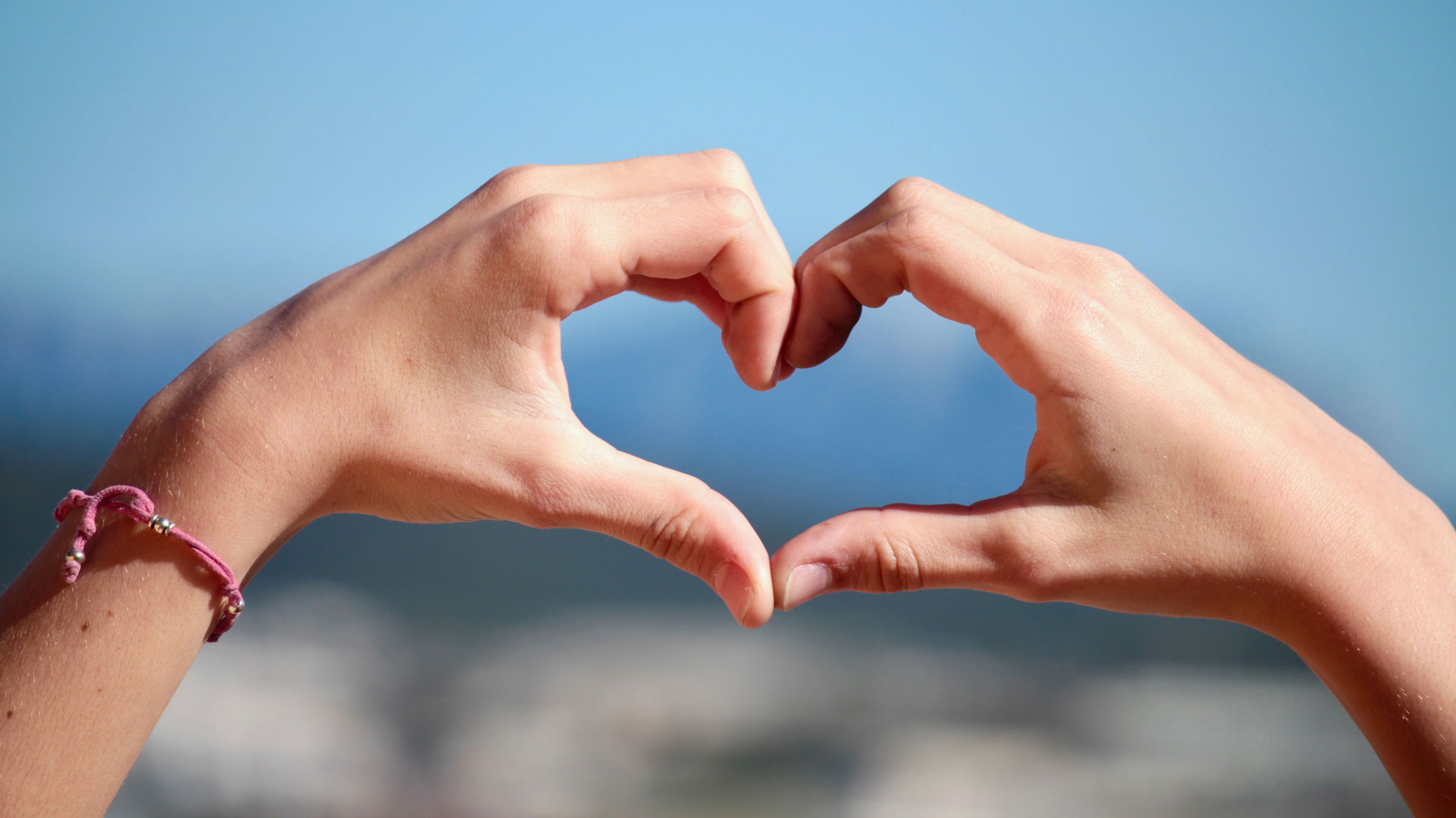 Fingers making the shape of a love heart