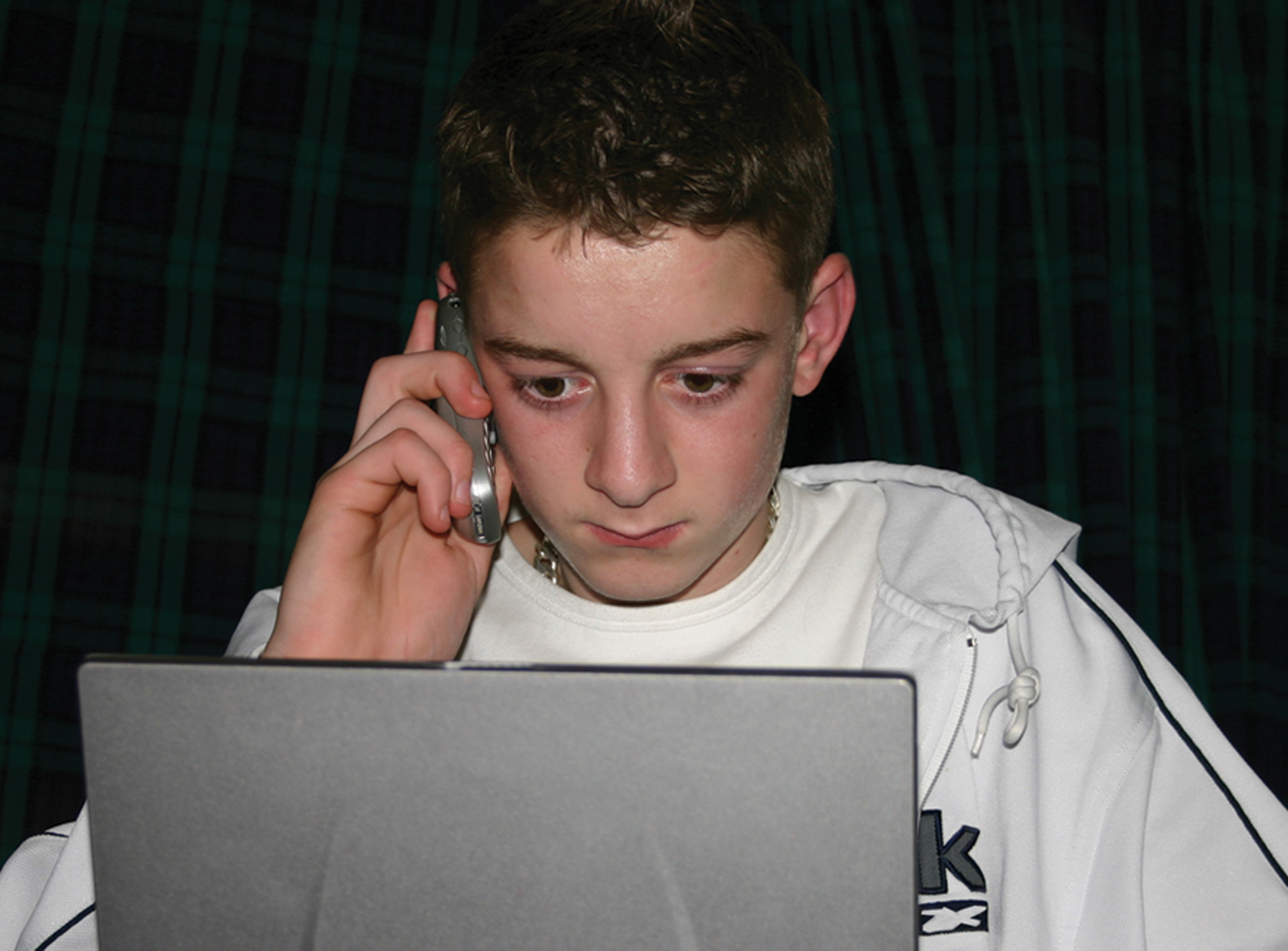 boy-on-laptop-and-mobilephone1440