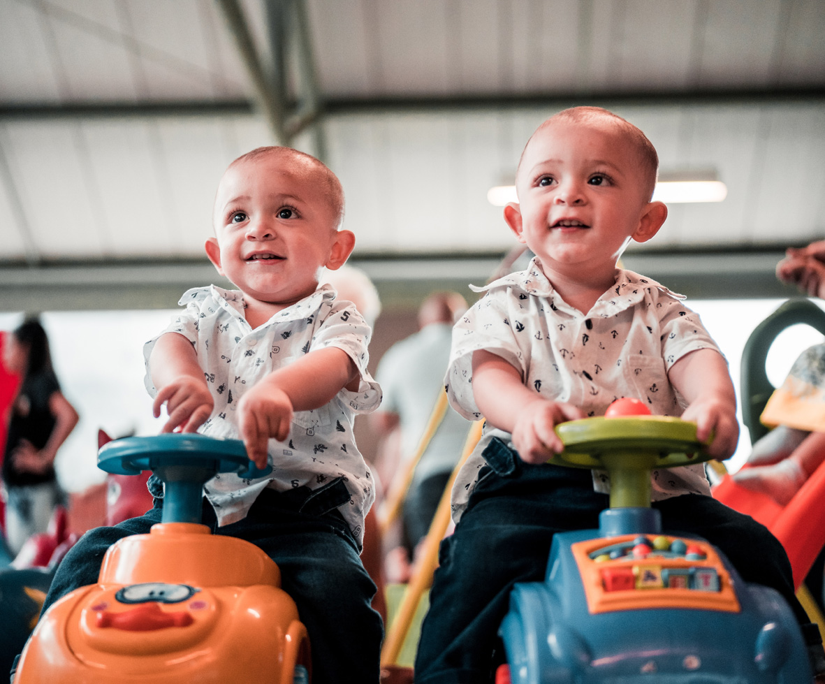 two-babies-sitting-on-toy-cars-3656309