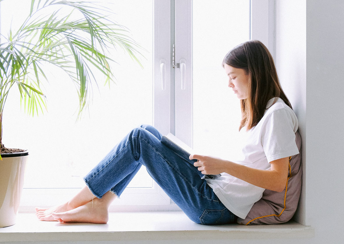 girl-reading-sitting-by-window2160