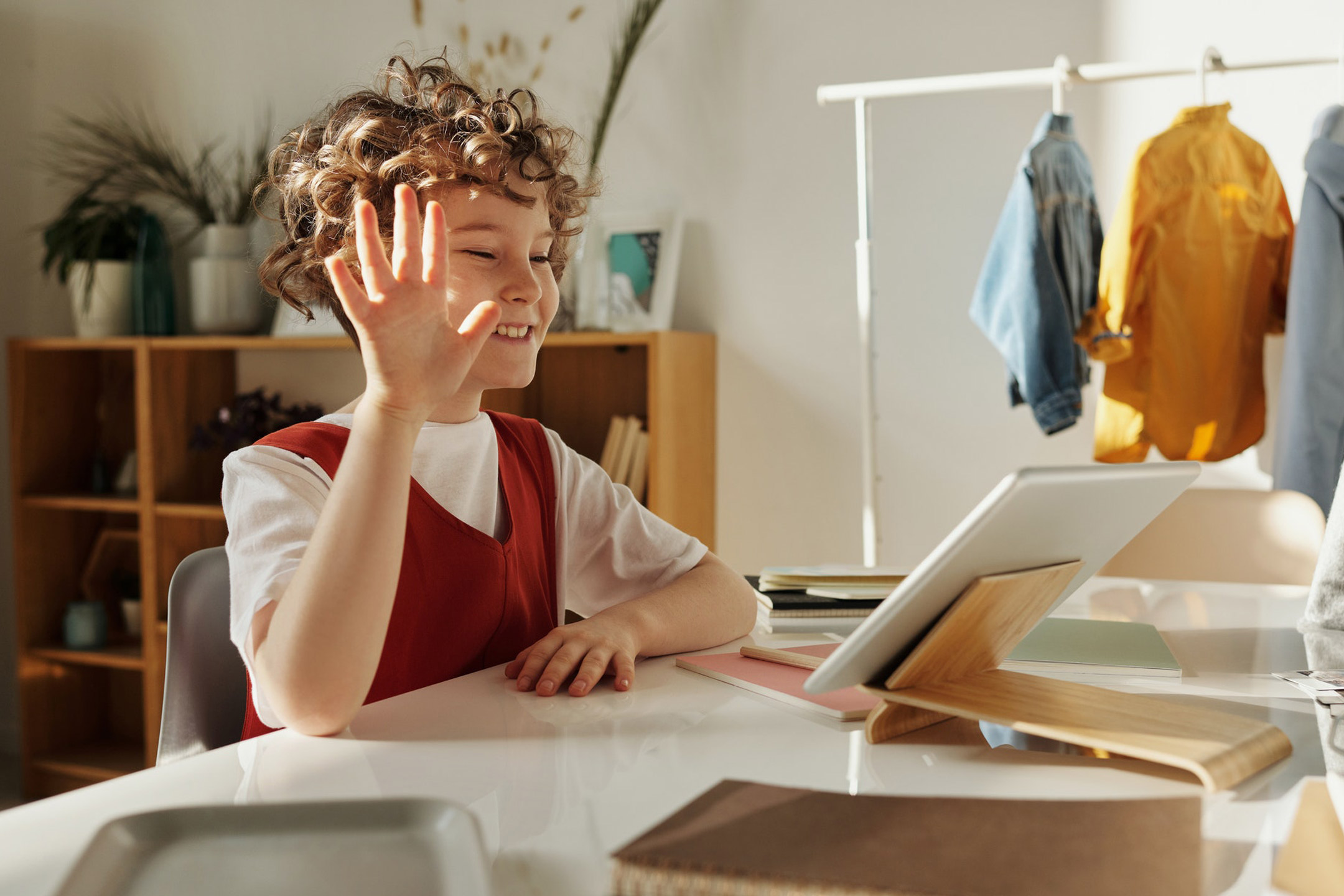 child-waving-at-tablet-video-call2160