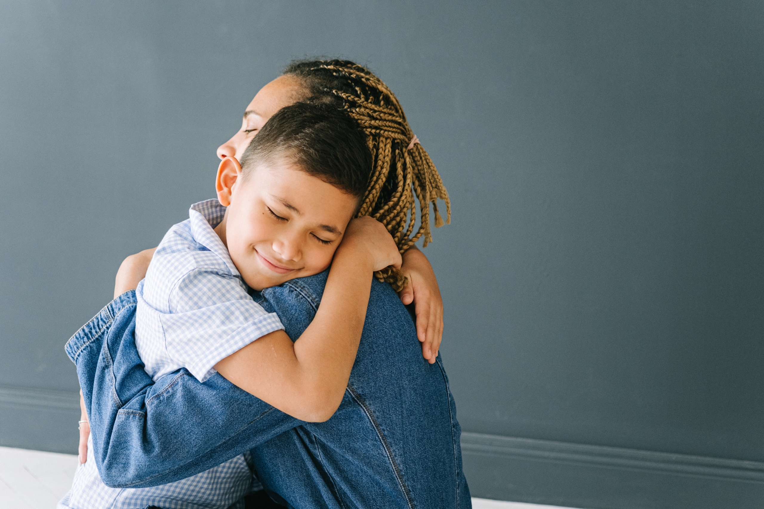 Tween boy hugging mum