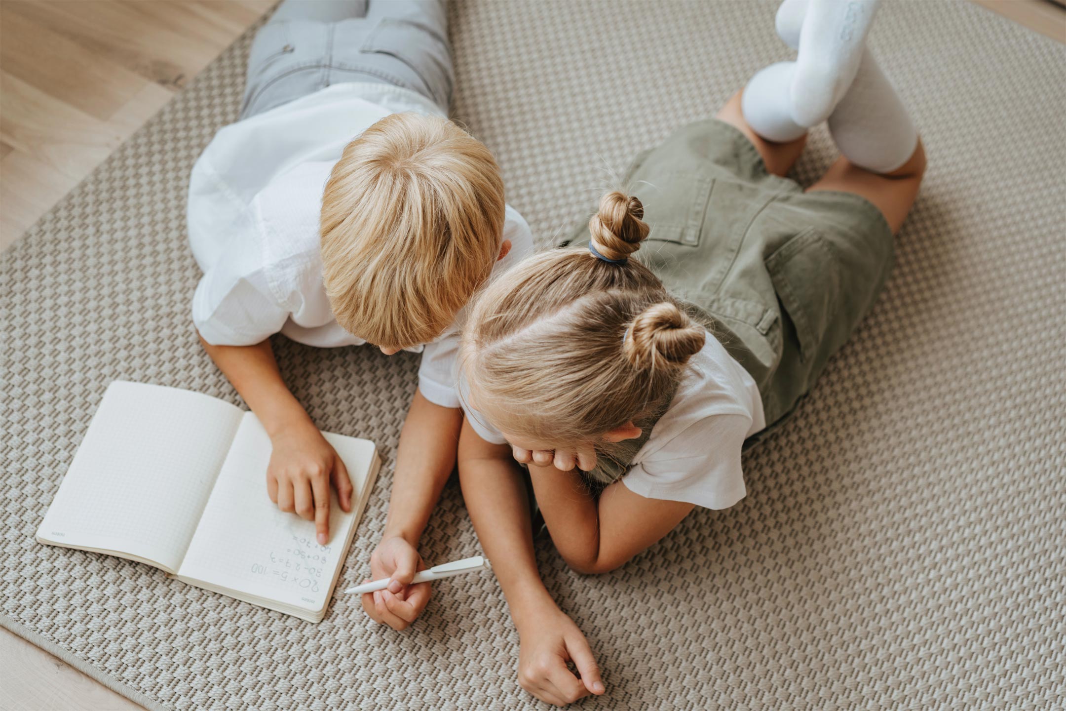 siblings-lying-down-writing2160