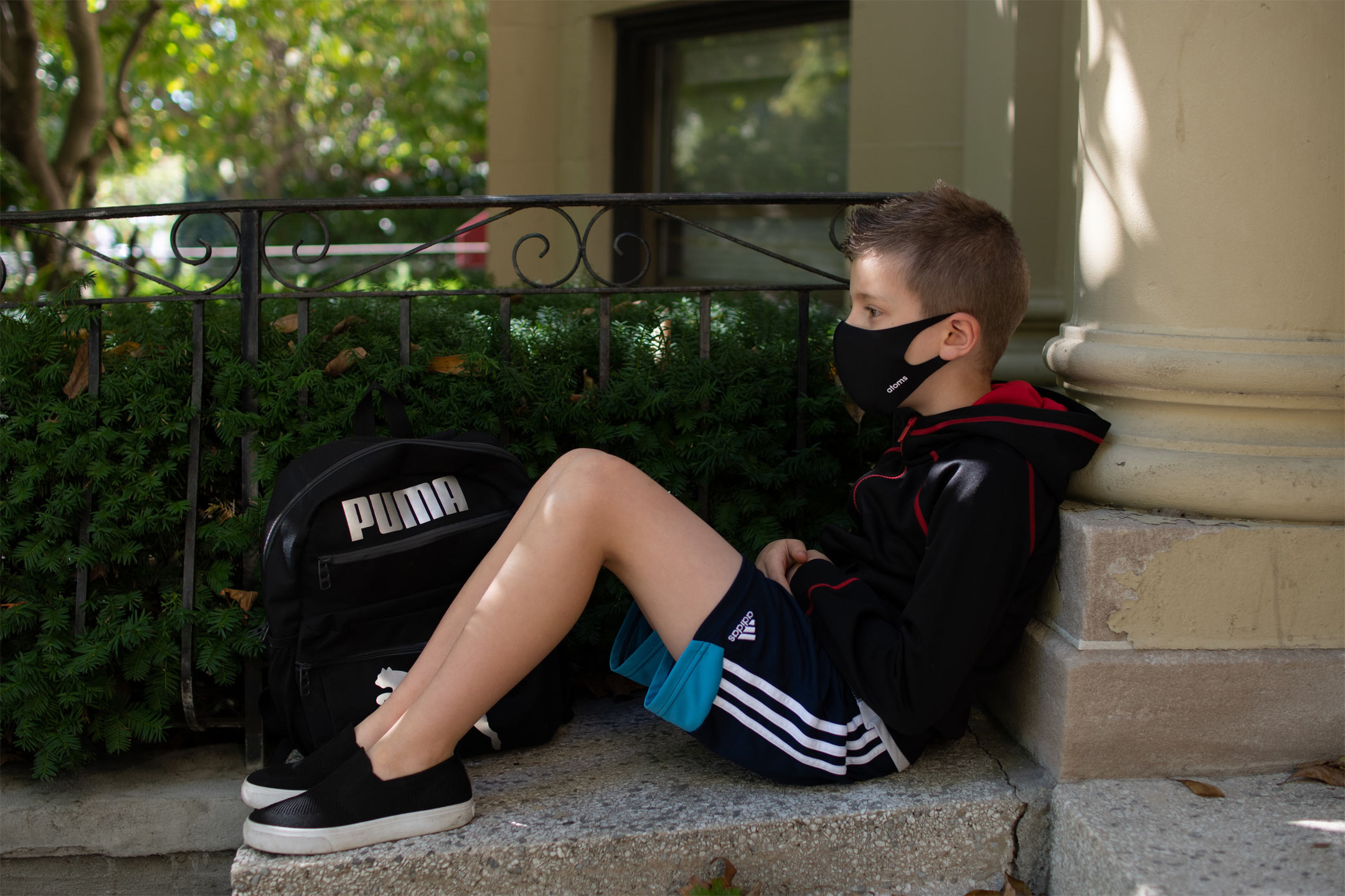 boy-sitting-staring-face-mask-on2160