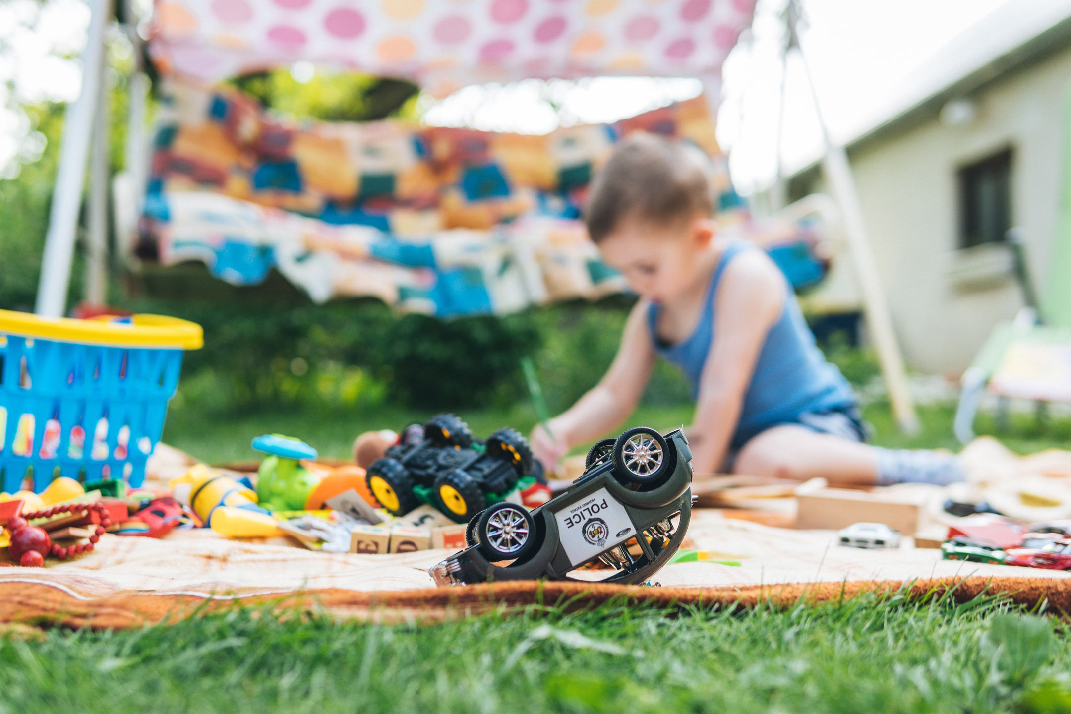 boy-on-mat-plying-outside2160