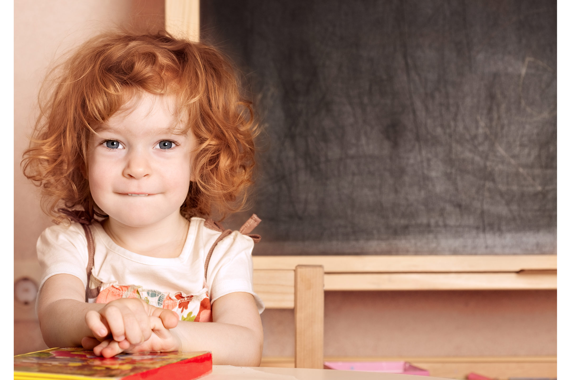 young-girl-with-book-at-kindy2160
