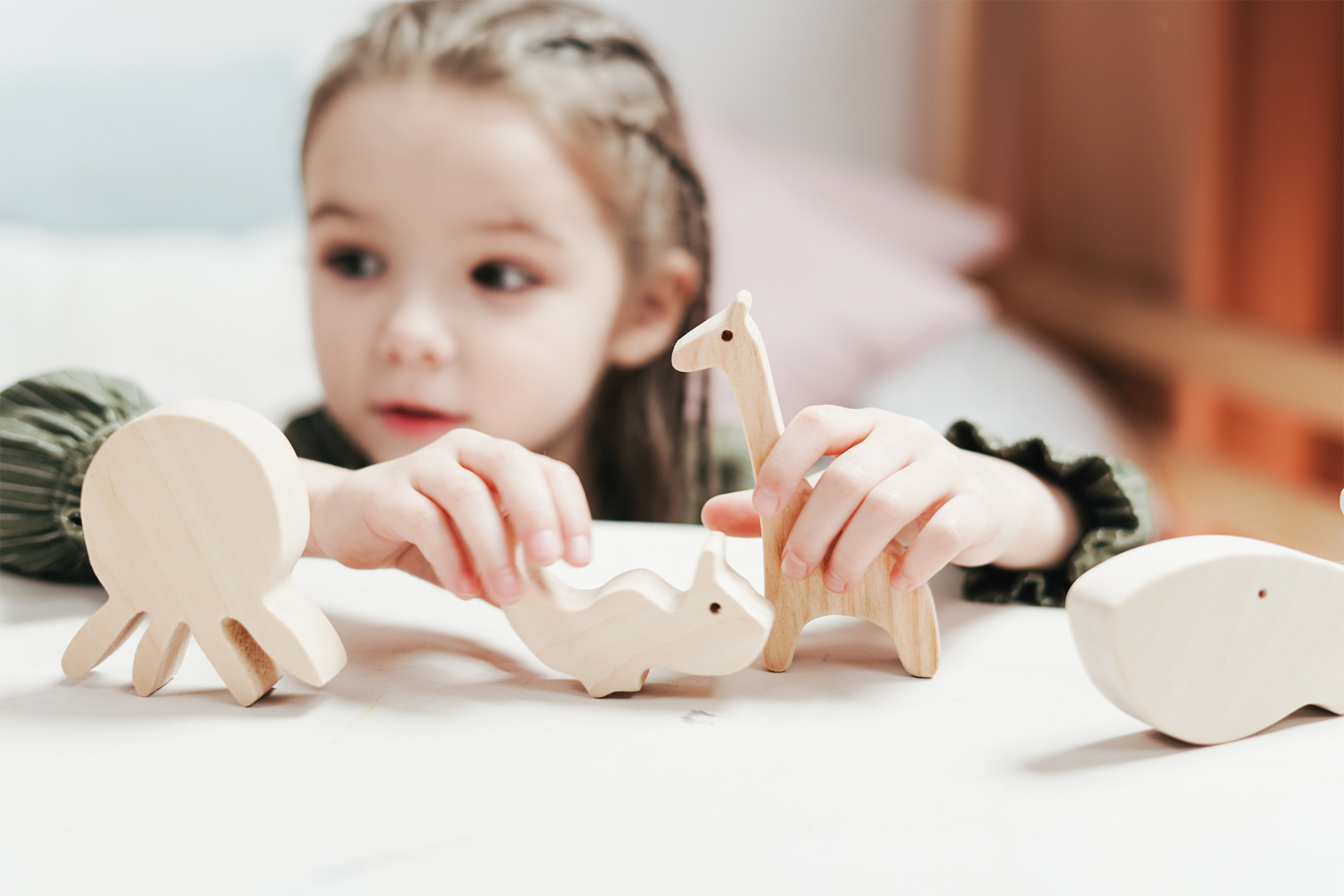 child-holding-wooden-toys2160