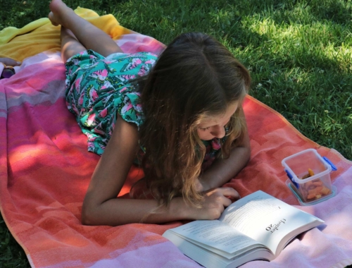 tween-girl-reading-on-grass2160
