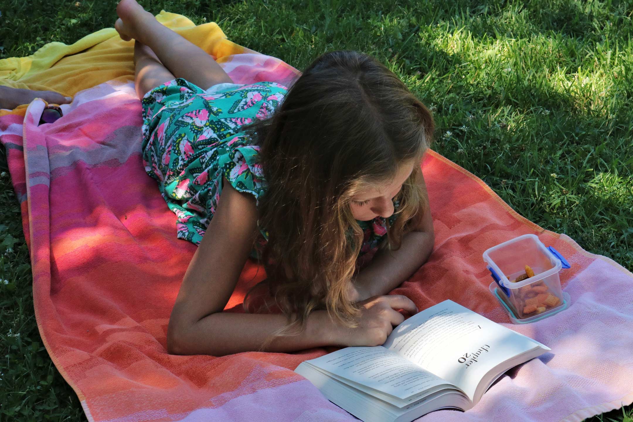 tween-girl-reading-on-grass2160