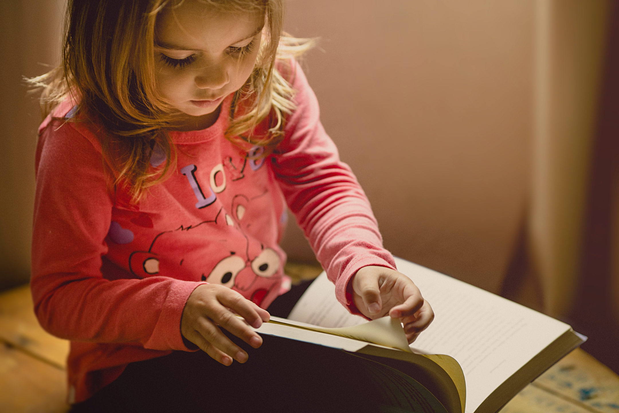 young-girl-looking-through-a-book2160