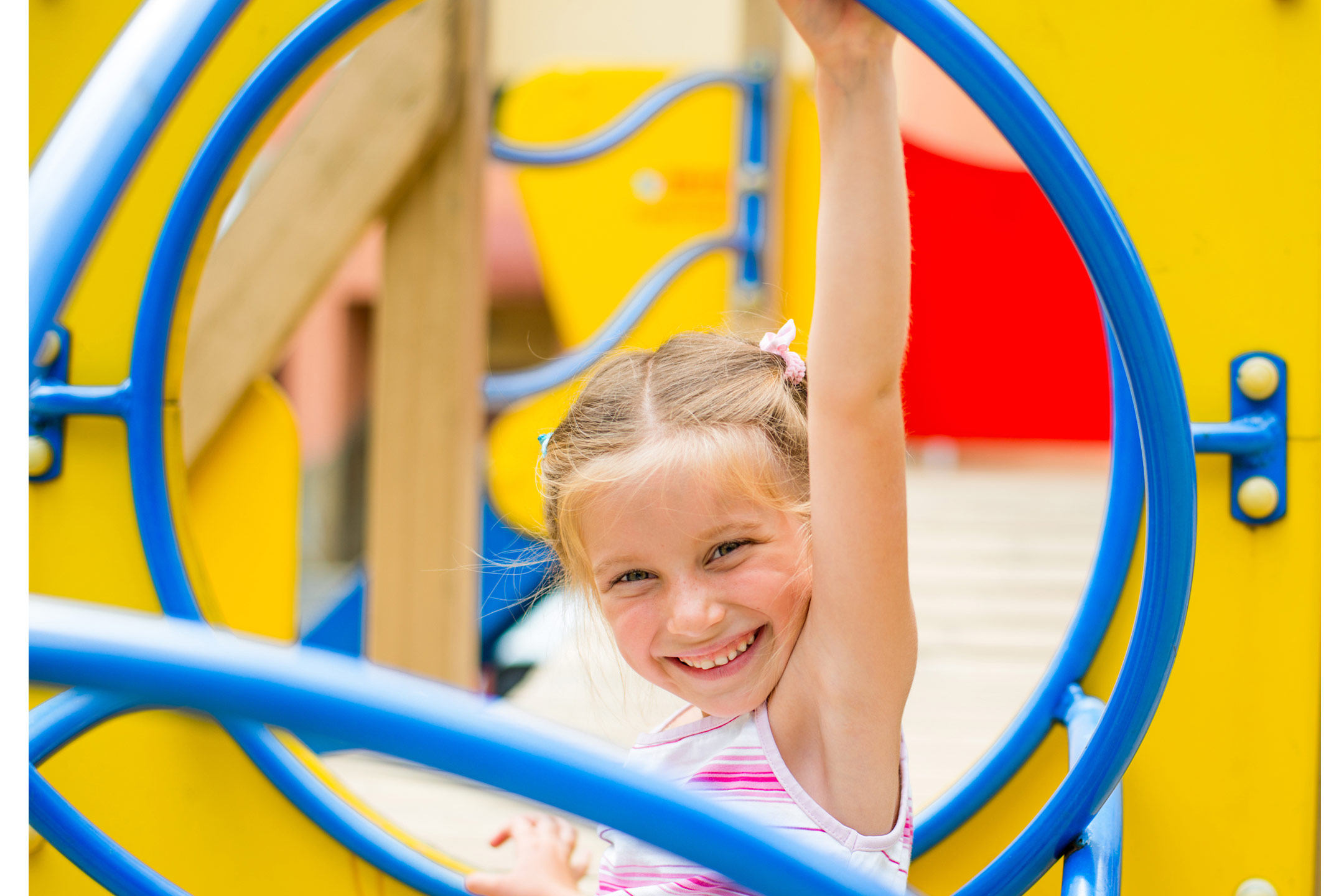 blond-girl-on-bright-play-equipment2160