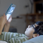 asian-boy-reading-tablet-in-bed2160