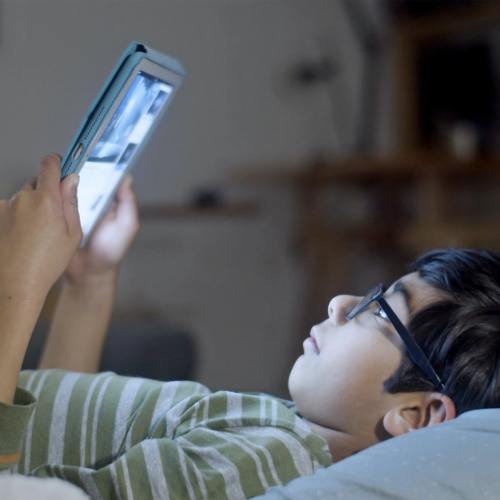asian-boy-reading-tablet-in-bed2160